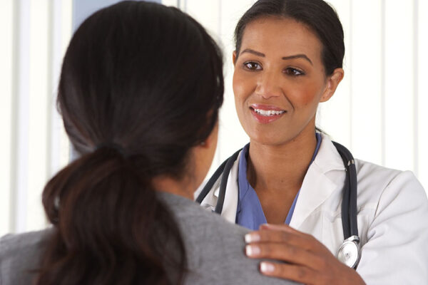 Close up of African American doctor talking to female patient